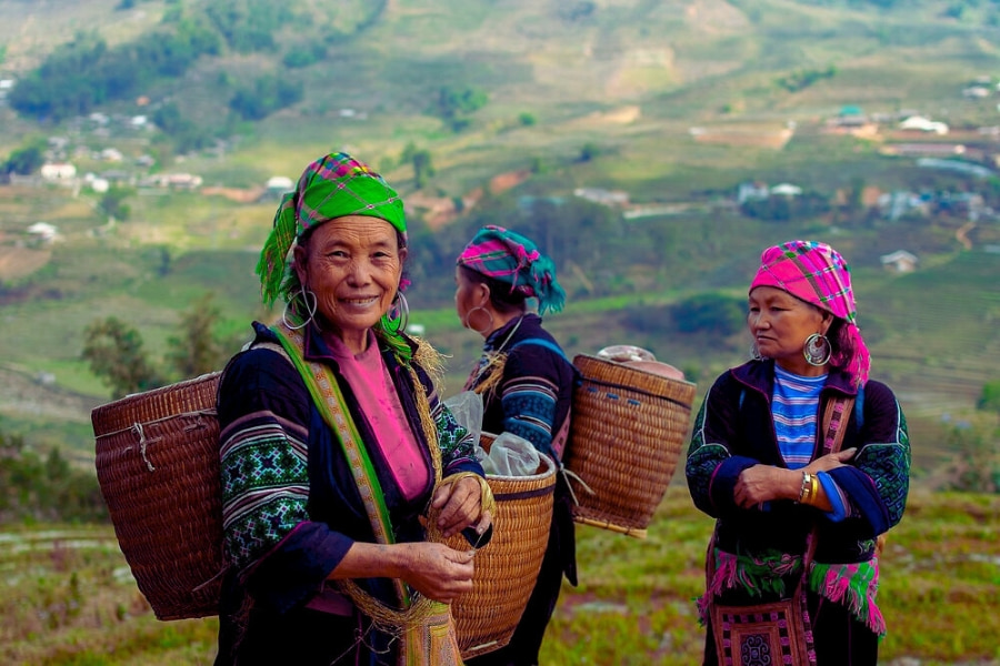Ethnic Hmong women in traditional dress with baskets in Sapa, Vietnam – Auasia Travel
